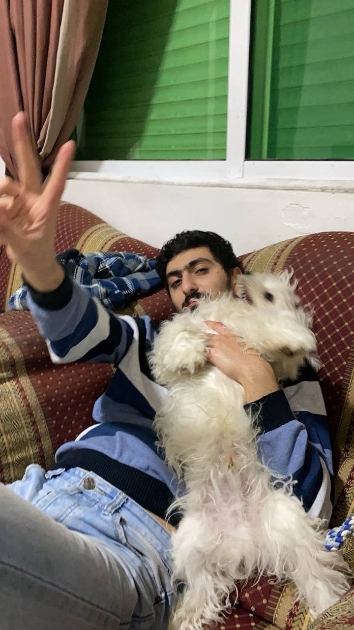 Zaid on couch with his dog